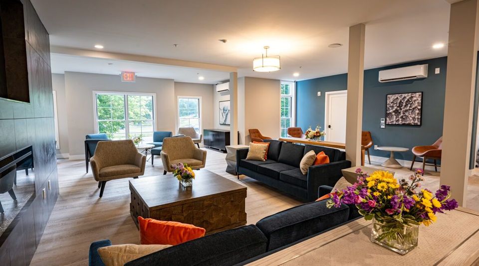 Open common room with sofas, armchairs and large windows at the Haddam campus