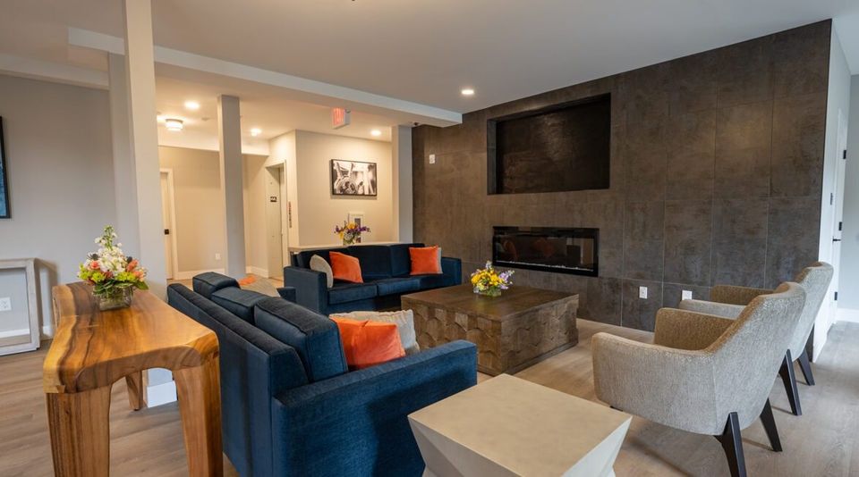 Lounge with blue sofas, armchairs and a fireplace at the Haddam campus
