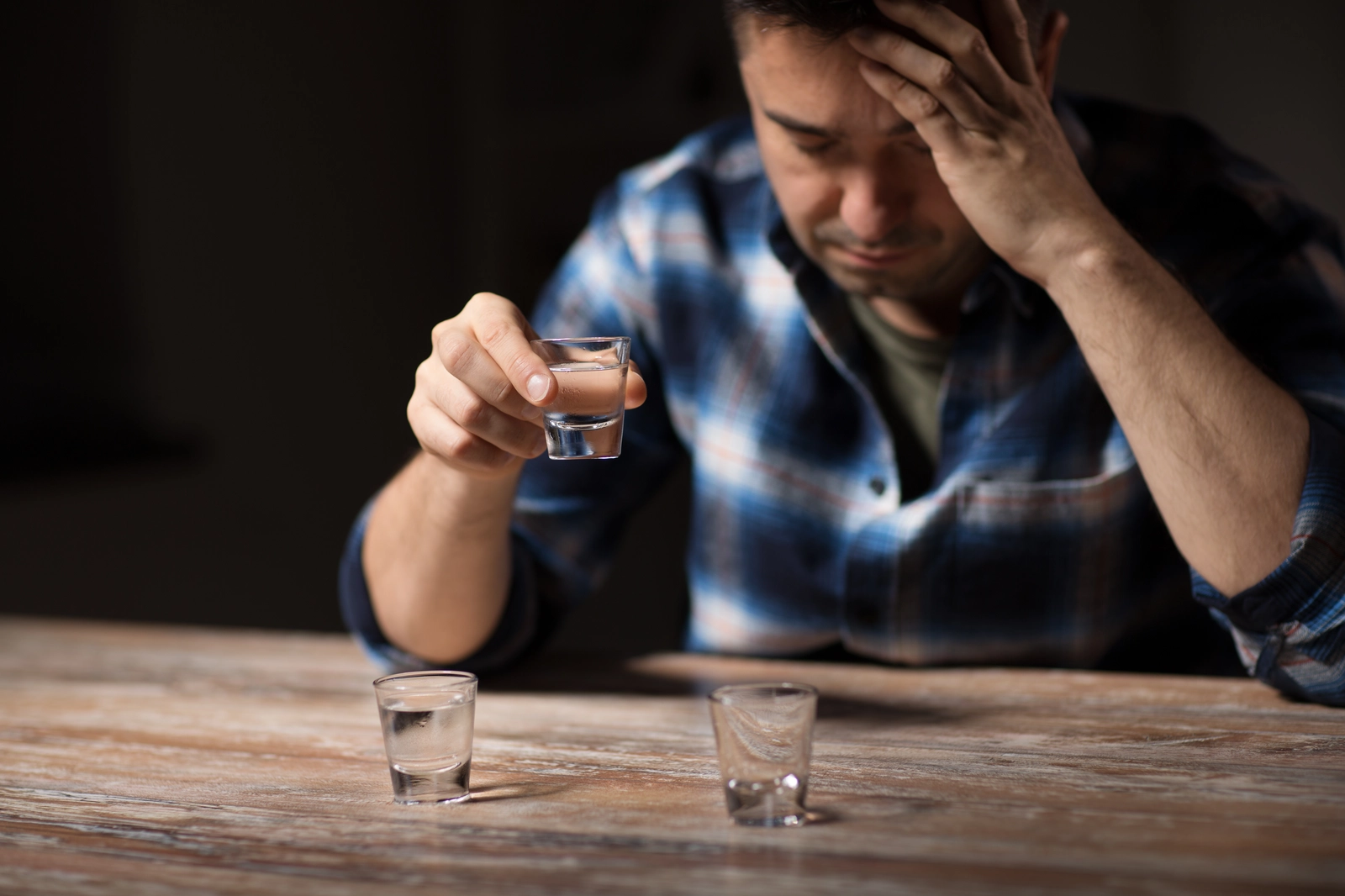 man drinking alcohol at a bar