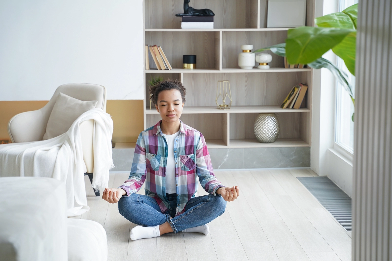 Take Care Of Yourself: A woman sitting on the floor meditating.