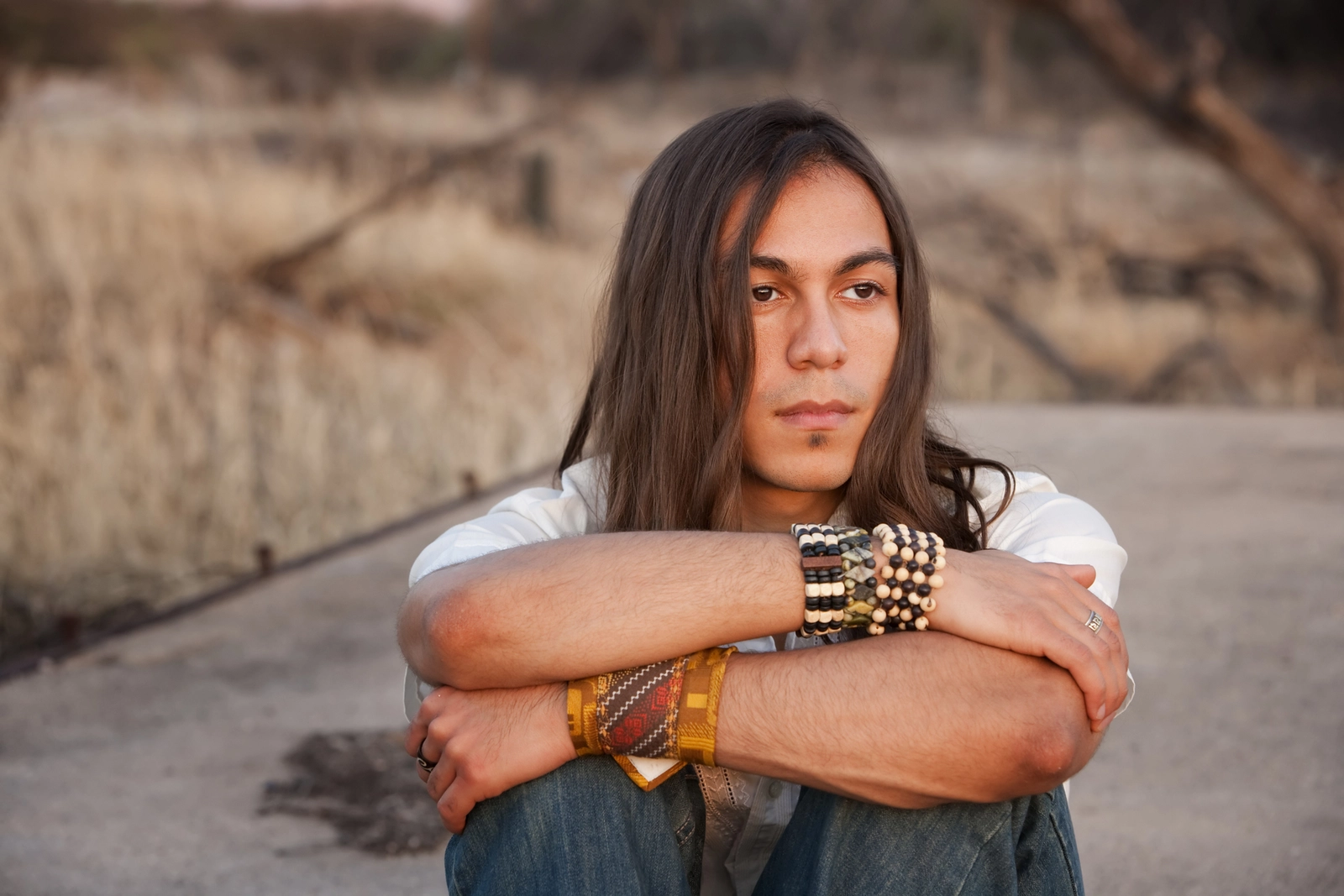 Native American Treatment Centers: A young man sitting outside.