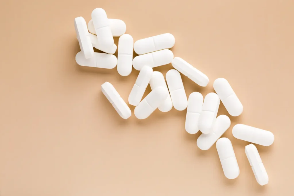 How Long Does Ambien Stay in Your System? White pills on table.